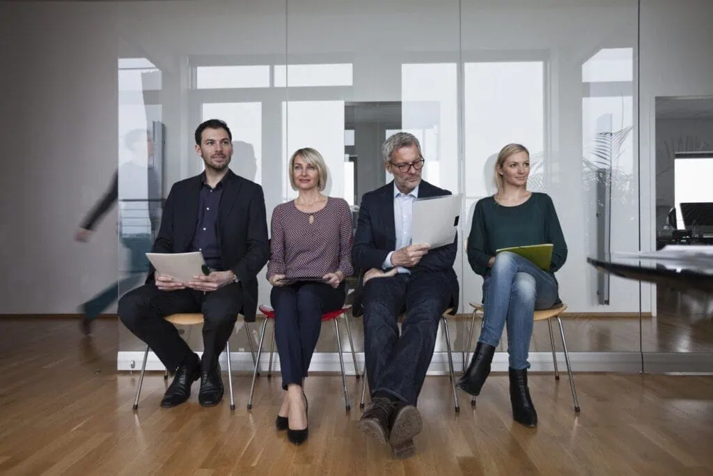 Portrait of a diverse group of applicants, with the logo of Datafield Technology Services visible in the background. The image highlights the concept of matching job requirements.