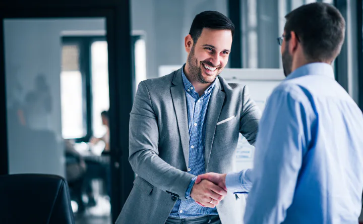 Image of two men shaking hands, featuring DataField Technology Services and highlighting telecommunications request for proposal.