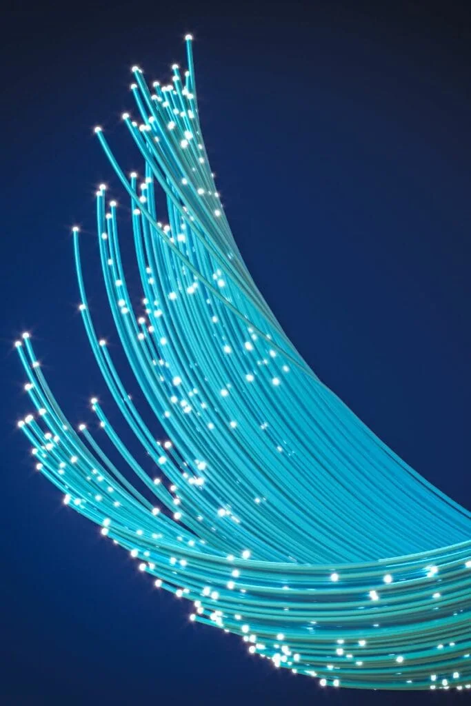 Fiber optic cable on blue background, featuring Data Field Technology Services and highlighting their expertise in innovative tech solutions.