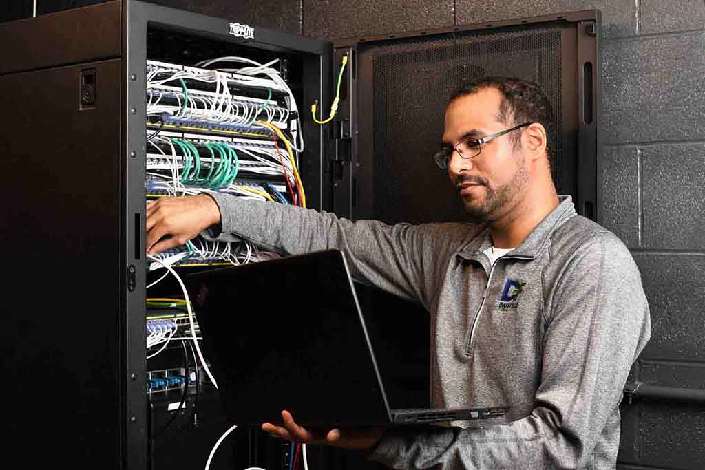 Image of a man holding a laptop, featuring DataField Technology Services and highlighting 'Equipment and Protocol Analysis,' ensuring alignment with the page's context.