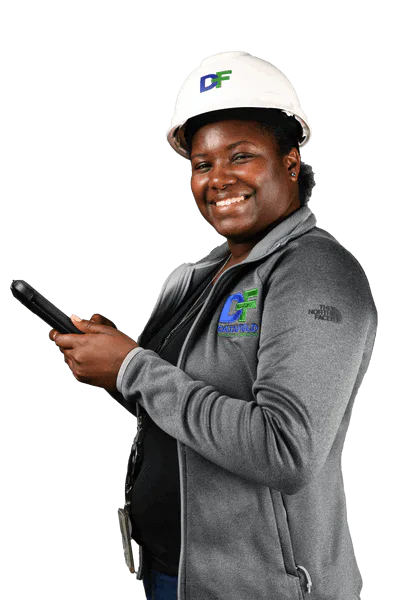 A woman wearing a hard hat and holding a cell phone, featuring Data Field Technology Services and highlighting their expertise in innovative tech solutions.