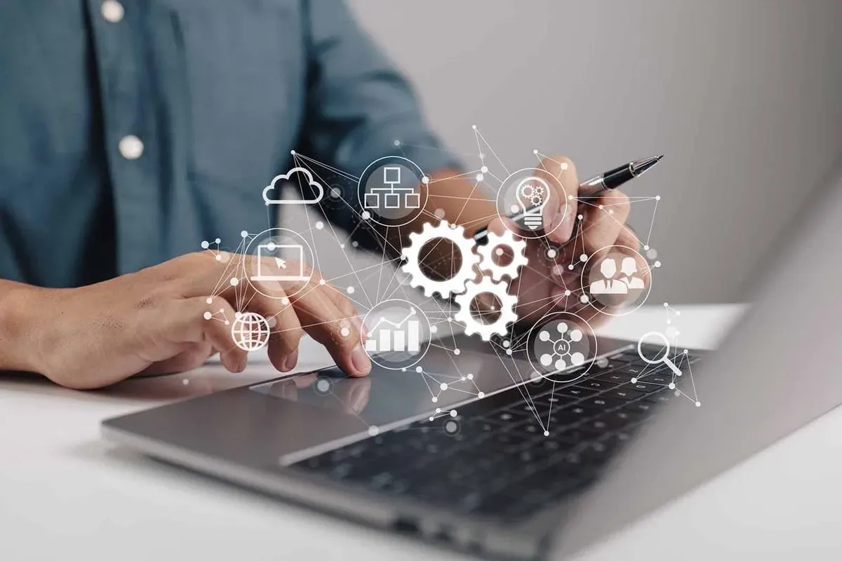 Image capturing a man working with a laptop, featuring DataField Technology Services and highlighting Telecom Automation Tools, ensuring alignment with the page's context.