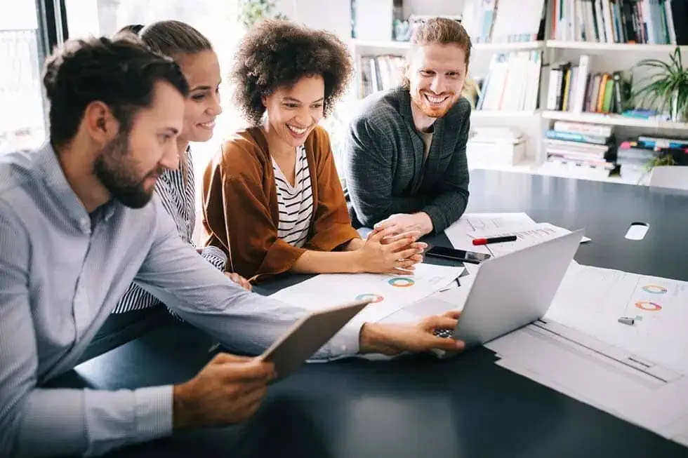Group in front of a laptop, featuring Datafield Technology Services, and highlighting The Right People in the Right Positions, seamlessly aligned with the page's context.