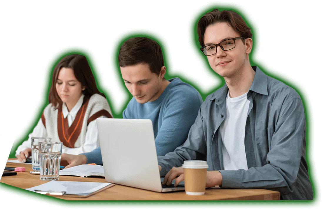 Three people working on laptops in a classroom, featuring Data Field Technology Services and highlighting their expertise in innovative tech solutions.