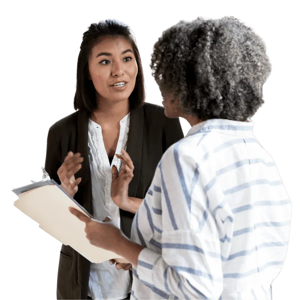 Two women talking to each other in a meeting, featuring Data Field Technology Services and highlighting their expertise in innovative tech solutions.